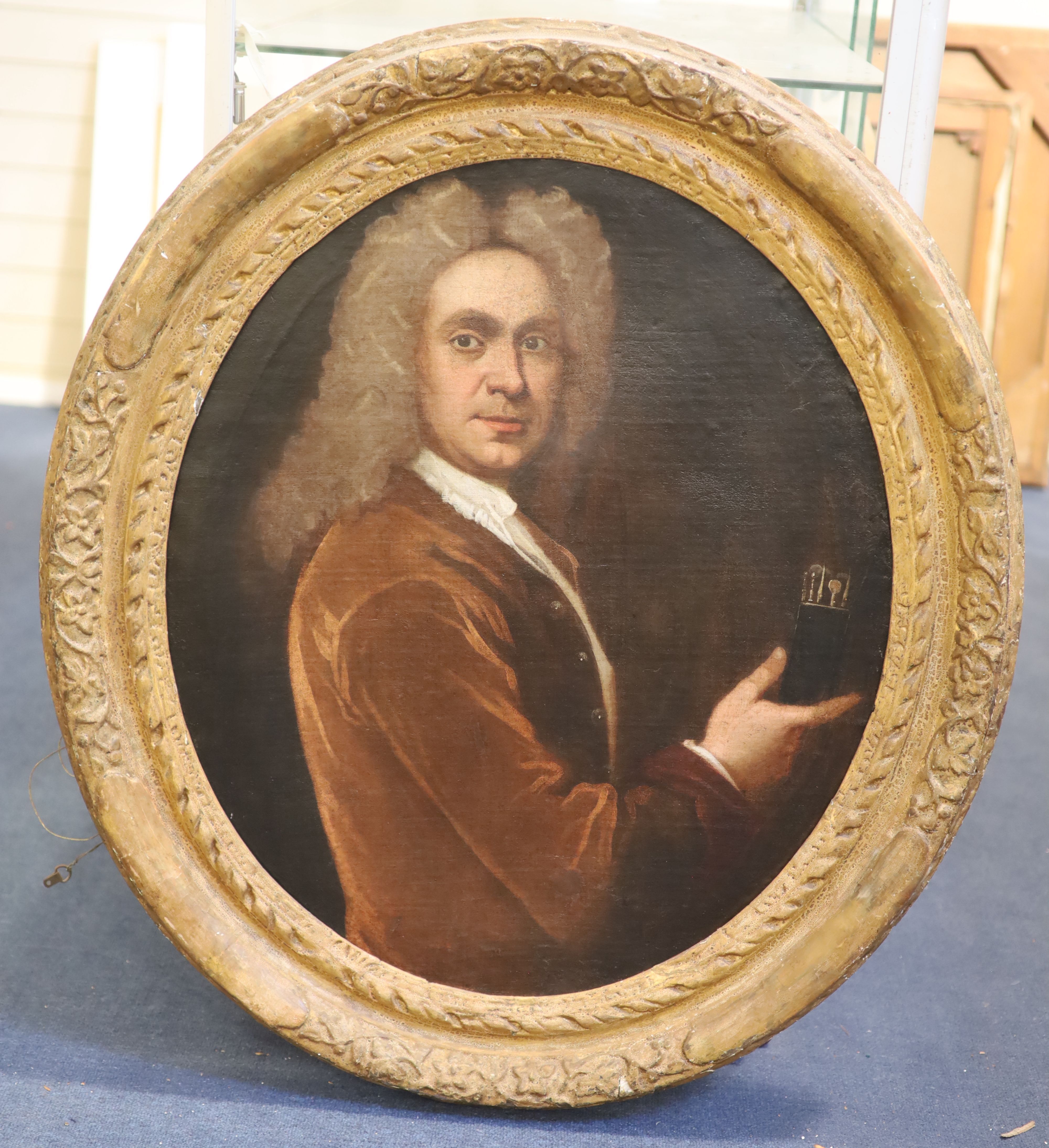 School of Sir Godfrey Kneller (1646-1723) Portrait of a gentleman holding a set of drawing instruments 29 x 24.5in.